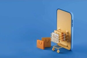 Alt: Smartphone mit Einkaufskorb und Einkaufst&uuml;ten, digitales Shopping, E-Commerce, Mobile Shopping.